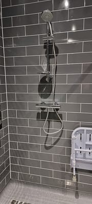 Emergency plumber repairing leaking shower in Bletchley property