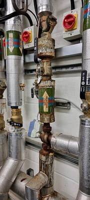Emergency plumber fixing water damage from leaking system in Bletchley