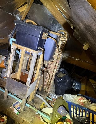 Emergency plumber working on hot water system in St Albans