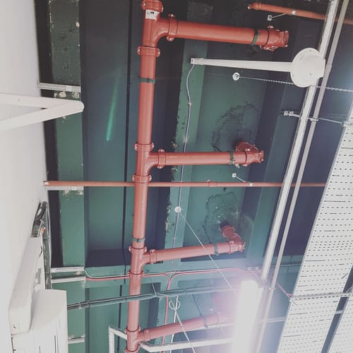 Professional plumber clearing blocked drain in Milton Keynes