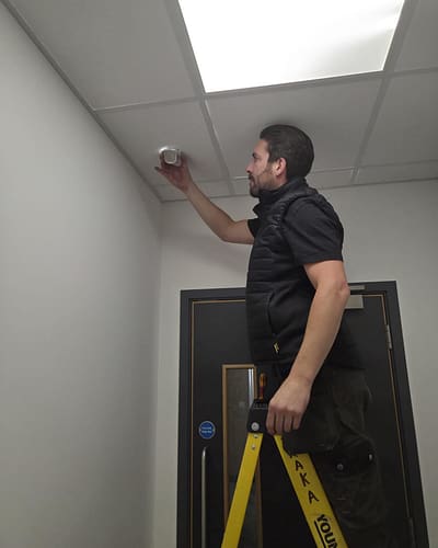 Electrician performing urgent repairs in a commercial building. Commercial emergency electrician working in Milton Keynes office